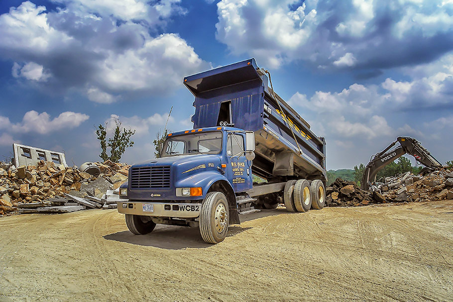 International Tandem Dump Truck Dumping Broken Asphalt from a Recent Demolition Project in Charlotte, NC. Image by W.C. Black and Sons, Inc.