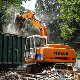 HALLA HE130-LCE Excavator loads demolition debris onsite of a demolition project in Charlotte, NC. Image by W.C. Black and Sons, Inc.